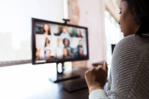 Woman video conferences with co-workers during shutdown