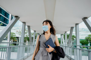 Young asian businesswoman wearing face mask and going to work